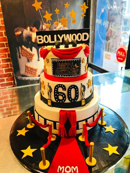 The full Bollywood premiere cake, featuring a film strip, awards, and a "Bollywood" sign.