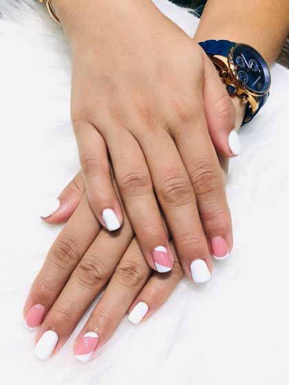 A still shot of the modern and clean pink and white color-block nails.