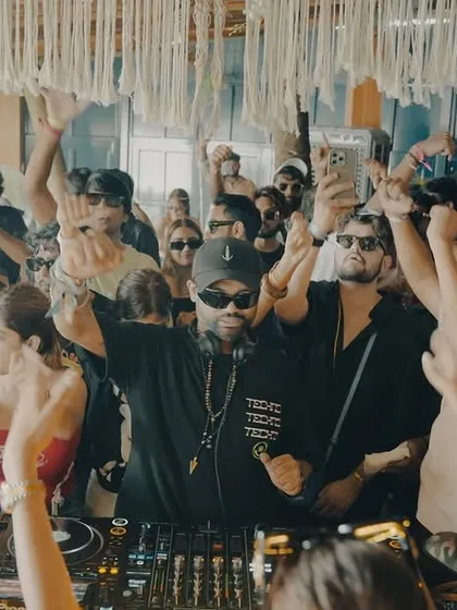 Hands up for the daytime madness in Goa. This shot captures the collective energy of a sun-soaked dance floor.