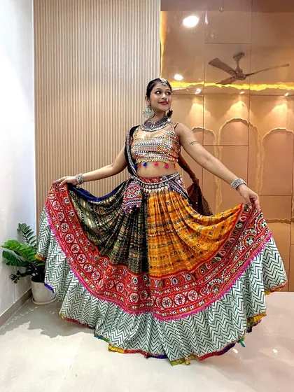 Standing tall and showing off the full outfit. This multi-colored chaniya choli is a celebration in itself, perfect for the festive spirit of Navratri.