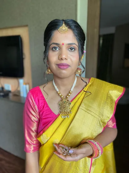 A full-face view of this elegant guest makeup. The look is traditional, with a focus on defined eyes and a neat hairstyle.