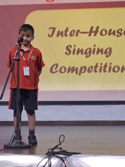A student from the primary grades takes his turn at the microphone during the singing competition.