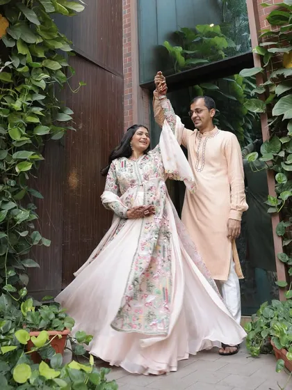 A playful, dancing shot with her husband. It's all about celebrating this joyful milestone together.