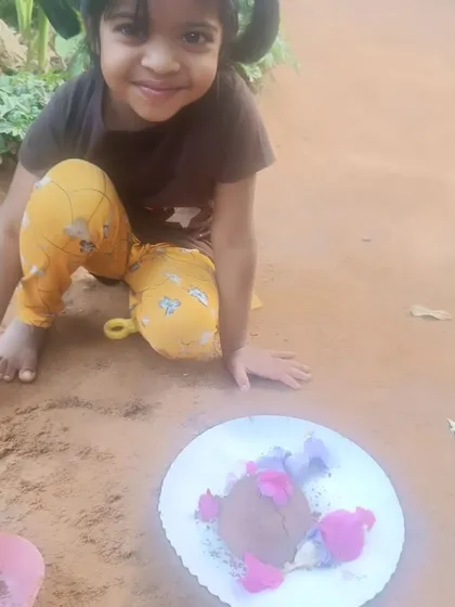 A happy smile from one of our young participants during a mud play activity. This image captures the simple, pure joy of sensory play and creative expression that we nurture in our workshops.