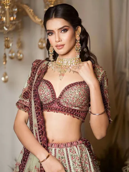 A close-up portrait of this regal look. The makeup is kept soft and stunning to complement the intricately embroidered lehenga and pastel jewelry.