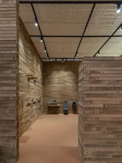 The entire stall, including walls and ceiling, is constructed from cardboard, demonstrating a commitment to innovative and sustainable exhibition design.