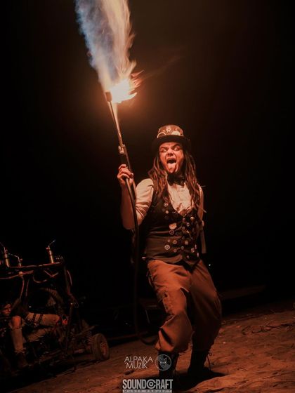A close-up of our steampunk fire gunner. The costume details, from the top hat to the vest, are as important as the prop itself in building a convincing retro-futuristic world for our audience.