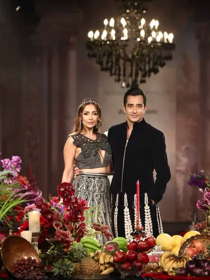 Malaika Arora and Rahul Khanna as showstoppers for Siddartha Tytler, framed by the opulent floral banquet I designed. The composition of flowers, fruits, and candelabras created a rich, dramatic stage for the collection's finale.