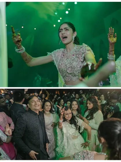 The bride and guests letting loose on the dance floor. The green lighting and energetic atmosphere show that a great Sangeet is all about having fun.