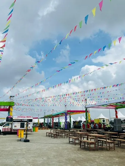 A wide view of the Ola factory event space, showing the large-scale tenting, food truck area, and seating arrangements I provided. This demonstrates my ability to manage large corporate family days.