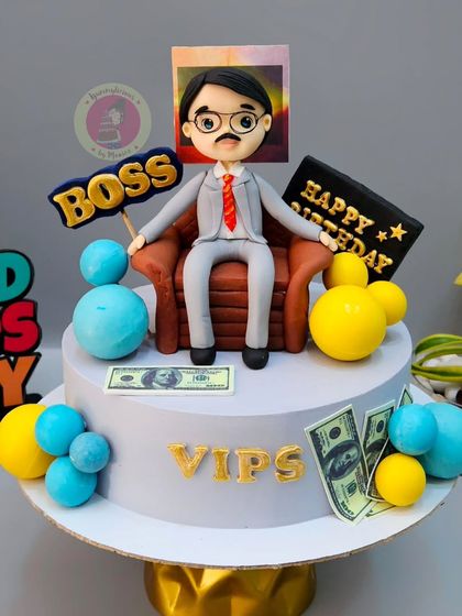 A cake for a CA, depicting him as the boss, complete with a custom figurine and money details.
