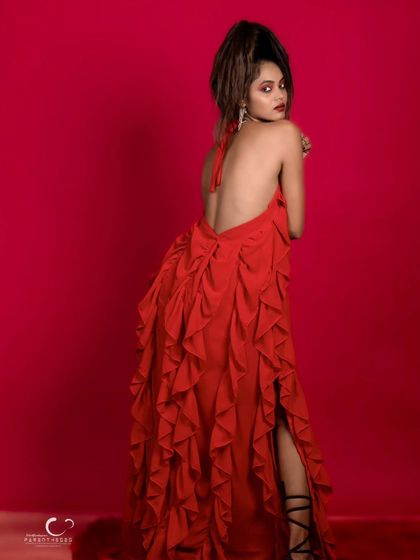 A beautiful and elegant pose that showcases the back of the dress and the model's graceful lines.