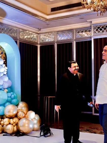 Dignitaries and guests enjoying the elegant setup at the 15th birthday party for Sri Rajkumar Patil Telkur's son.