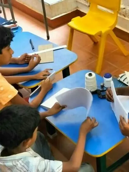 A group of children completely engaged in a bookbinding workshop at Poorna Learning Centre. We partner with schools and community centers to make repair skills accessible to as many kids as possible.