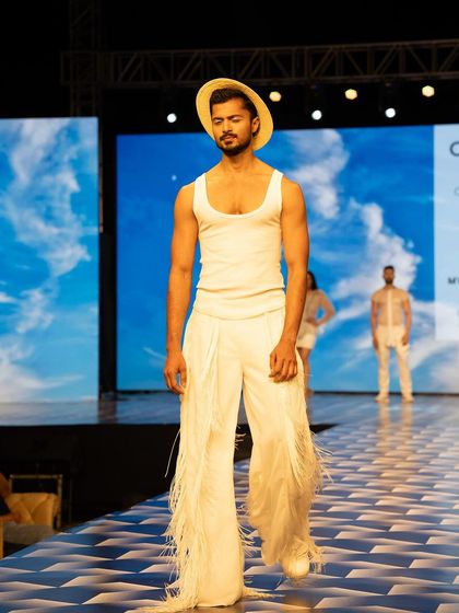 Walking the runway in a Chaitanya Rao creation featuring fringed trousers. The movement of the fringe adds a dynamic element to the walk.