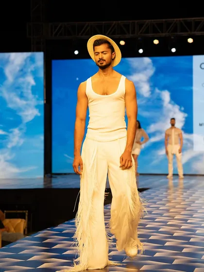 Walking the runway in a Chaitanya Rao creation featuring fringed trousers. The movement of the fringe adds a dynamic element to the walk.