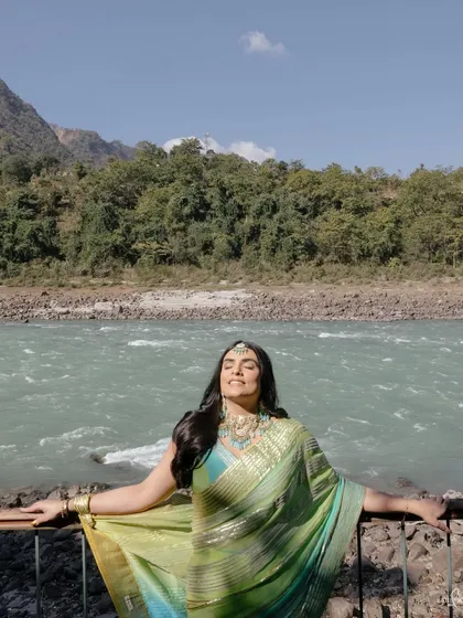 Pragya soaks in the sun on the banks of the Ganges. This portrait captures a moment of pure bliss and connection with nature, reflecting the spiritual vibe of her wedding.