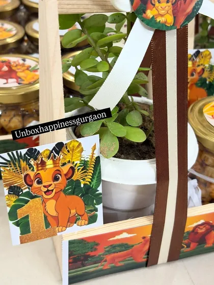 A detailed view of the 'Lion King' first birthday favor, showing the number "1" tag with a cute Simba graphic.