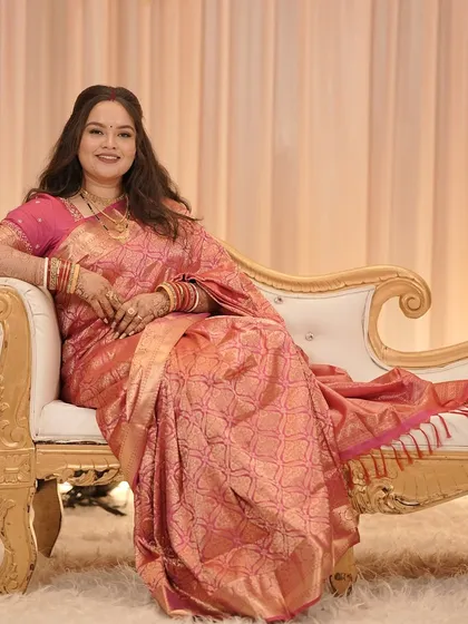 A full-length portrait of the bride on a chaise lounge, looking regal.
