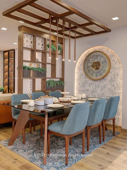 This dining space is defined by its elegant wooden partition with built-in planters, creating a natural separation from the living area while maintaining an open, airy feel.