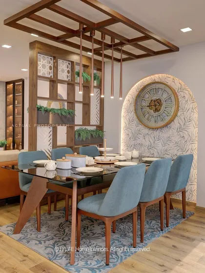 This dining space is defined by its elegant wooden partition with built-in planters, creating a natural separation from the living area while maintaining an open, airy feel.