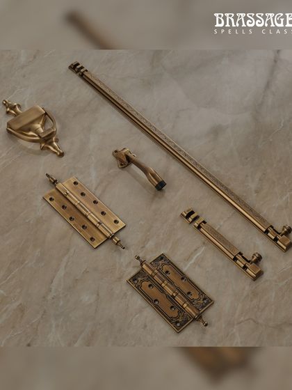 The Volga Collection offers a complete door solution. This image displays a door knocker, hinges, a tower bolt, and a door stopper, all designed with the same ornamental flair to ensure a unified and elegant aesthetic.