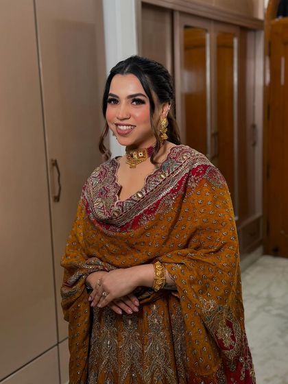 A stunner in a traditional mustard-colored outfit. I created a warm-toned makeup look with a soft smokey eye and a pretty half-up hairstyle.