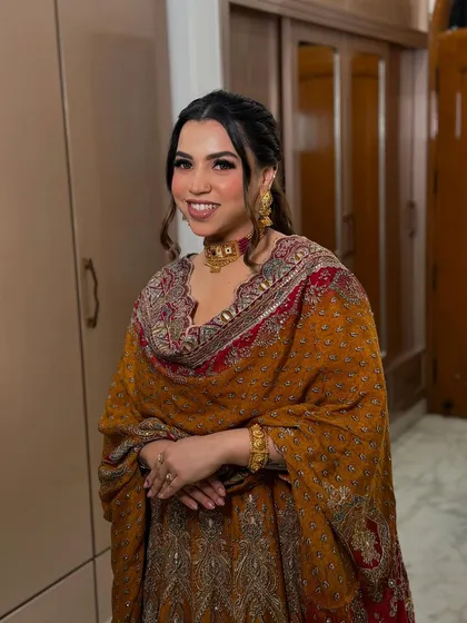 A stunner in a traditional mustard-colored outfit. I created a warm-toned makeup look with a soft smokey eye and a pretty half-up hairstyle.