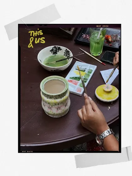 An art date in progress, with watercolors, brushes, and a cup of matcha on the table.