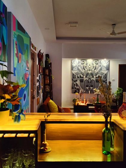 A view of my studio's bar and living area at night, illuminated to create a warm, inviting, and creative atmosphere.