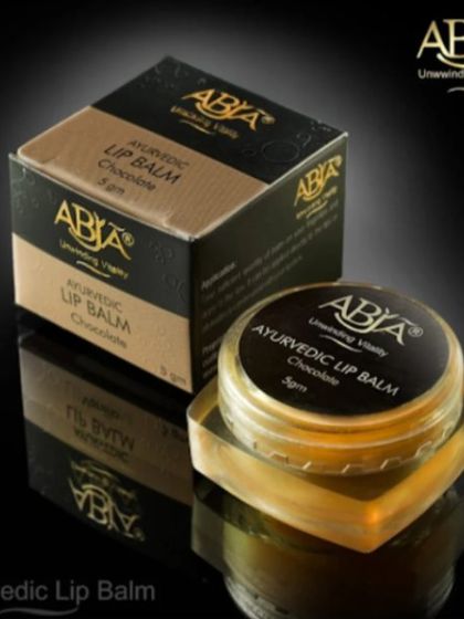A product shot of my Ayurvedic Lip Balm in Chocolate, crafted to provide deep hydration and protection.