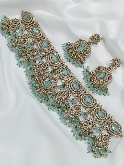 A mint-green version of the same intricate choker design.