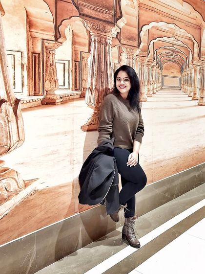 A cozy winter outfit with a brown sweater, black pants, and boots, perfect for a chilly day.