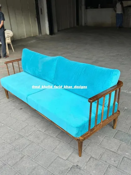Full view of the three-seater turquoise sofa.