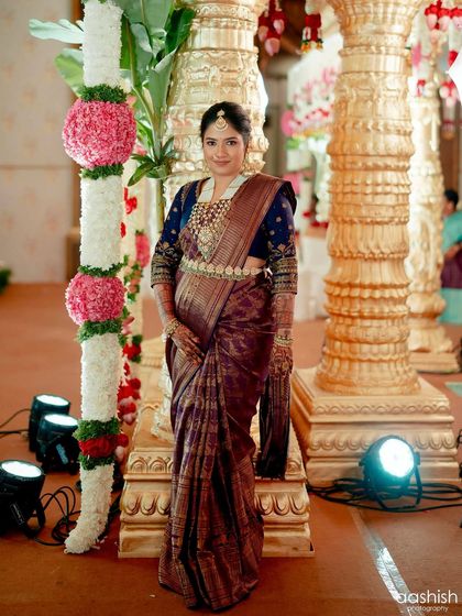 A wide shot capturing the grandeur of the event and the client's stunning traditional ensemble.