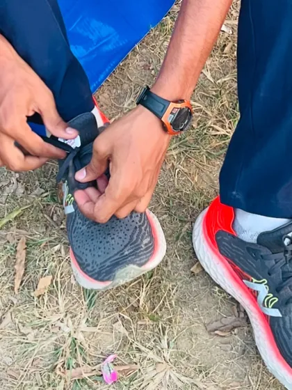 An athlete lacing up his new shoes. This simple act represents a new beginning and a step towards achieving his goals.