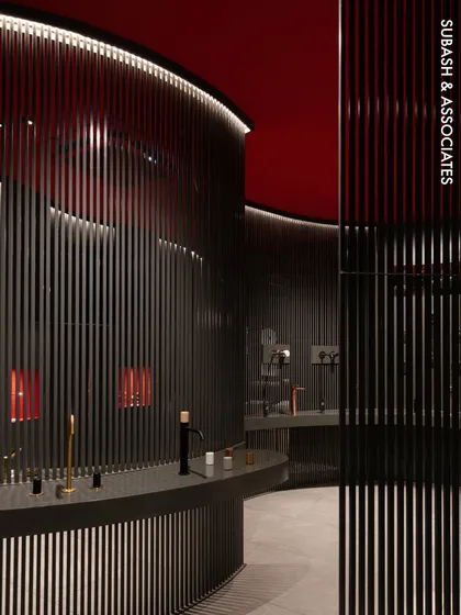 A view into the FIMA Store, where we used vertical steel partitions and a bold red ceiling to create an immersive, gallery-like experience. This design guides customers through a curated space, highlighting products with dramatic lighting and a strong color palette.