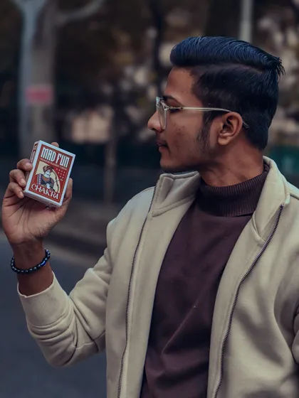 "My sole ambition is to love myself without limits." A moment of self-reflection, holding a deck of cards that represents my passion.