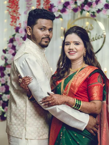 A classic posed portrait of the couple, looking directly at the camera, capturing their happiness.