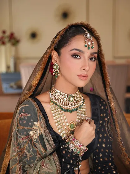 A close-up showcasing the minimal magic of this bridal look. Paired with a multi-hued Divani lehenga, the makeup features soft matte eyes and a satin-finish skin, creating a modern yet traditional aesthetic.