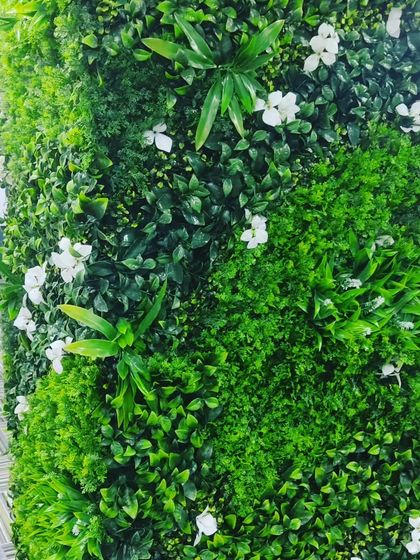A close-up of the office pillar installation. You can see the mix of light and dark green foliage that creates a vibrant, textured surface.