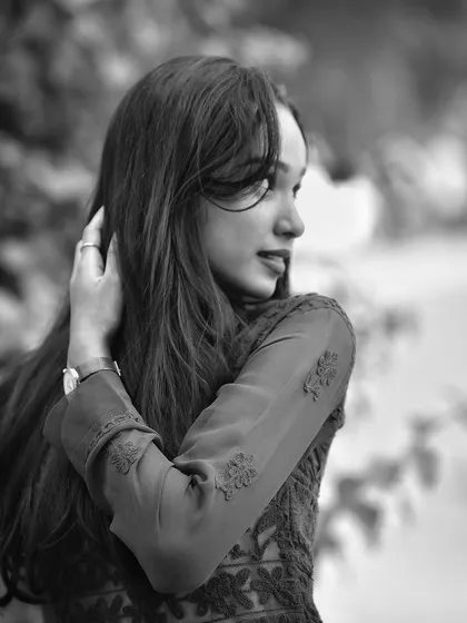 A beautiful black and white portrait with a soft, dreamy feel. The focus on her profile and the gentle light create a timeless and artistic image.