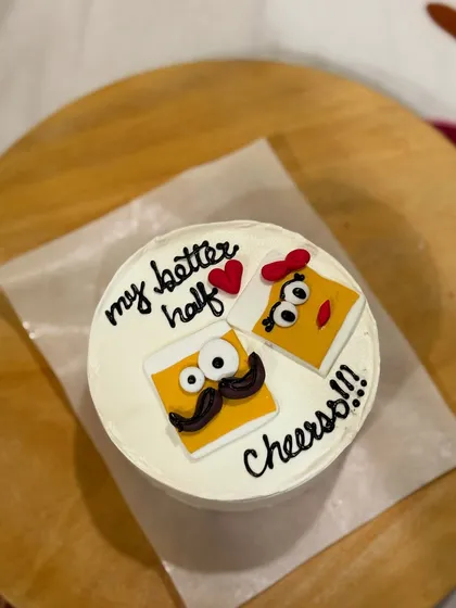 A quirky anniversary cake with cartoon cheese slices for "my better half". A fun and unique way to celebrate your love.