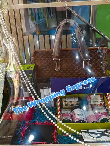 Another angle of the groom's trousseau hamper, showing the arrangement of the laptop bag and other gifts.