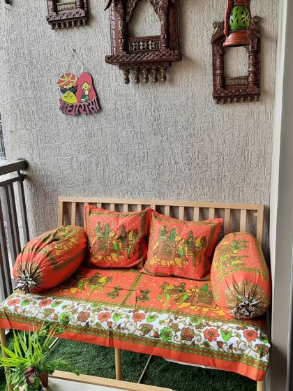 A wide shot of the Rajasthani-inspired balcony, showing how the seating arrangement fits perfectly into the space. The hanging lantern and wall decor complete the ethnic, colourful theme.