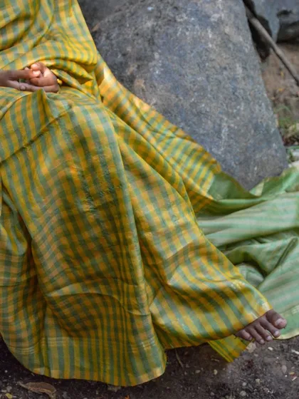 A detail of the Genda Phool Kosa Silk Saree, showing its graceful drape. This classic handloom saree comes with a blouse piece, making it a complete, timeless ensemble.