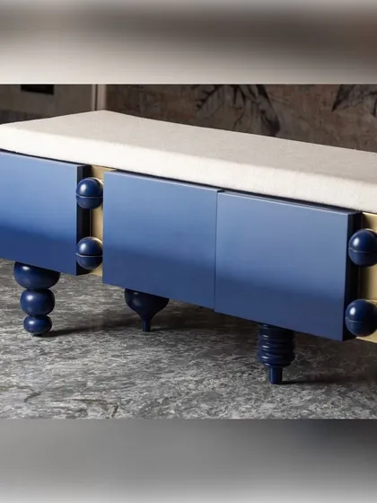 A full view of the ombre blue bench, showcasing its sculptural form and the interplay of its different leg designs. This piece blurs the line between furniture and art, providing both seating and a strong visual statement.