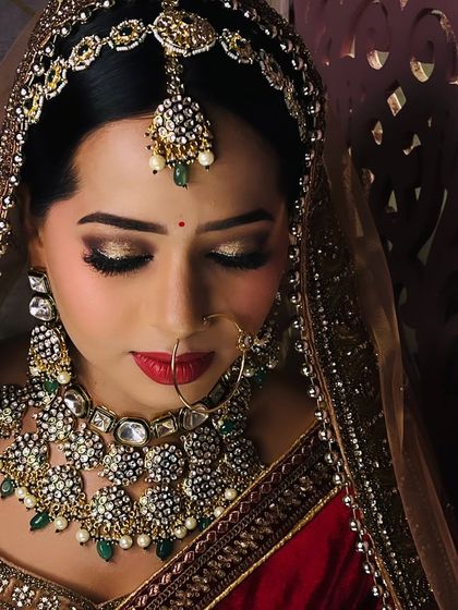 A close up of this bride's beautiful makeup. The golden glittery eyes and red lips are a perfect combination for a grand bridal look.