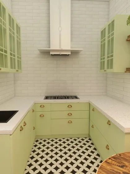 A compact yet stylish U-shaped kitchen design. The pastel green cabinets, white subway tile backsplash, and patterned floor create a bright and cheerful cooking space, perfect for smaller homes.
