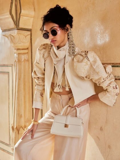 Power-packed and stylish. This Indo-Western set with a structured jacket and puffed sleeves is a high-fashion statement for the modern woman.